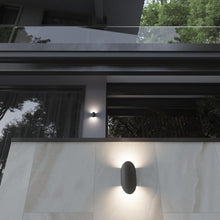 Load image into Gallery viewer, Remy Outdoor LED Wall Light in Outside Area.