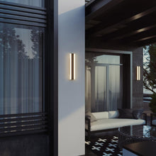 Load image into Gallery viewer, Rhea Outdoor LED Wall Light in Outside Area.