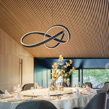 Load image into Gallery viewer, Twirl LED Pendant Light in dining room.