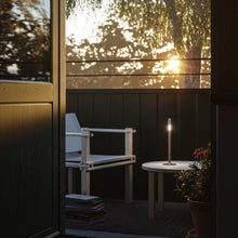 Load image into Gallery viewer, Glim Outdoor LED Portable Table Lamp in Outside Area.