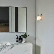 Load image into Gallery viewer, Globe Wall Light in bathroom.