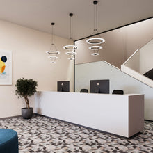 Load image into Gallery viewer, Arctic Rings™ Triple Ring LED Pendant Light in office.