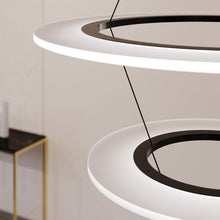 Load image into Gallery viewer, Arctic Rings™ Triple Ring LED Pendant Light in living room.