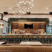 Load image into Gallery viewer, Suspenders® Ring LED Pendant Light in restaurant.
