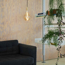Load image into Gallery viewer, Voronoi II Medium Base A52 Type LED Bulb in living room.