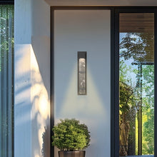 Load image into Gallery viewer, Sol Outdoor LED Wall Light in Outside Area.