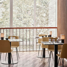 Load image into Gallery viewer, Manhattan SC52 Portable Table Lamp in restaurant.