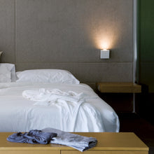 Load image into Gallery viewer, Alpha Wall Sconce in bedroom.