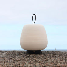 Load image into Gallery viewer, Misko Camp LED Table Lamp in Outside Area.