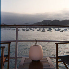 Load image into Gallery viewer, Misko Camp LED Table Lamp in Outside Area.