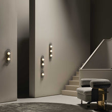 Load image into Gallery viewer, Modulo LED Wall Light in living room.