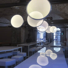 Load image into Gallery viewer, Discovery LED Vertical Suspension Light in restaurant.