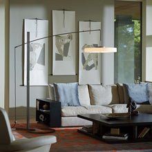 Load image into Gallery viewer, Disq Arc LED Floor Lamp in living room.