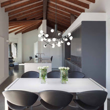 Load image into Gallery viewer, Moto LED Chandelier in dining room.