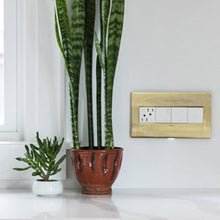 Load image into Gallery viewer, adorne® Energy-Saving On/Off Outlet in living room.