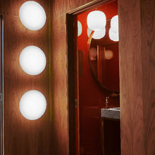 Load image into Gallery viewer, AJ Eklipta Wall Light in bathroom.