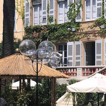 Load image into Gallery viewer, Lyndon Outdoor Floor Lamp in outside area.