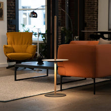 Load image into Gallery viewer, Nivel Pedestal LED Table Lamp in living room.