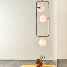 Load image into Gallery viewer, Sircle LED Vertical Pendant Light in living room.