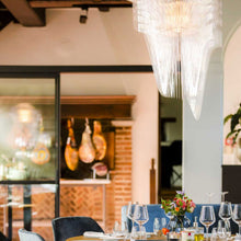Load image into Gallery viewer, Aria LED Chandelier in living room.