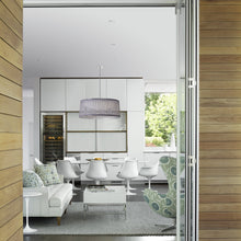 Load image into Gallery viewer, Solis LED Drum Pendant Light in living room.