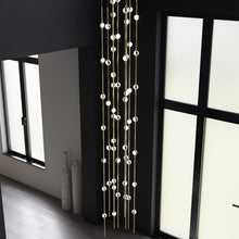 Load image into Gallery viewer, Constellation® Andromeda Round LED Pendant Light in living room.