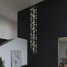Load image into Gallery viewer, Constellation® Andromeda Round LED Pendant Light in living room.