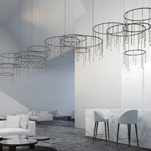 Load image into Gallery viewer, Suspenders® Offset Ring Horizontal Matrix LED Suspension Light in living room.