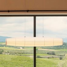 Load image into Gallery viewer, Colonne LED Pendant Light in living room.
