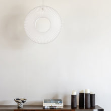 Load image into Gallery viewer, Iris LED Pendant Light in living room.
