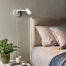 Load image into Gallery viewer, Ascoli Swing Plug-In Wall Light in bedroom.
