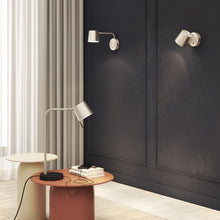 Load image into Gallery viewer, Miura LED Swing Arm Wall Light in living room.
