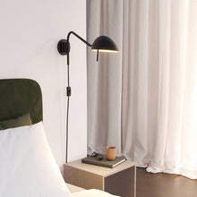 Load image into Gallery viewer, Serge Plug-In Wall Light in bedroom.
