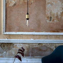 Load image into Gallery viewer, Buster Medium Base 120V LED Bulb in living room.
