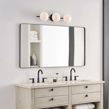 Load image into Gallery viewer, Lune LED Vanity Wall Light in bathroom.
