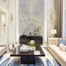 Load image into Gallery viewer, Astor By Robin Baron LED Linear Chandelier in living room.
