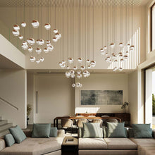 Load image into Gallery viewer, Grapes® 24-Light Round LED Multipoint Pendant Light in living room.
