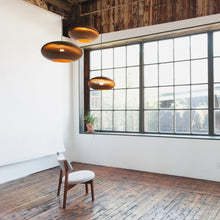 Load image into Gallery viewer, Disc Pendant Light in living room.

