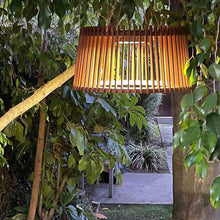 Load image into Gallery viewer, Muse Pendulum Outdoor Solar LED Pendant Light in Outside Area.
