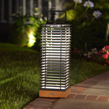 Load image into Gallery viewer, Tekura Outdoor Solar LED Lantern in Outside Area.
