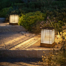 Load image into Gallery viewer, Tekura Outdoor Solar LED Lantern in Outside Area.
