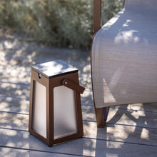Load image into Gallery viewer, Tinka Outdoor Solar LED Lantern in Outside Area.
