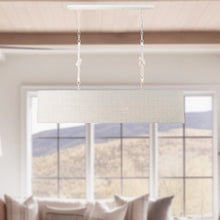 Load image into Gallery viewer, Lodelle Linear Pendant Light in living room.
