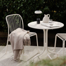 Load image into Gallery viewer, Blossi LED Mini Portable Table Lamp in Outside Area.
