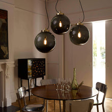 Load image into Gallery viewer, Globe Pendant Light in dining room.
