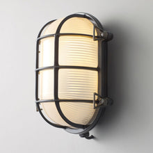 Load image into Gallery viewer, Oval Brass Bulkhead Indoor/Outdoor Wall Light in Detail.
