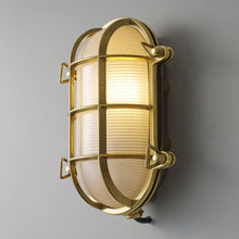 Load image into Gallery viewer, Oval Brass Bulkhead Indoor/Outdoor Wall Light in Detail.
