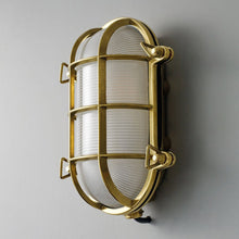 Load image into Gallery viewer, Oval Brass Bulkhead Indoor/Outdoor Wall Light in Detail.
