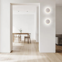 Load image into Gallery viewer, Totem Puck LED Wall Light in living room.
