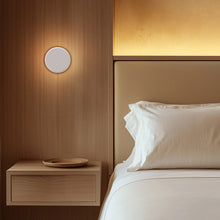 Load image into Gallery viewer, Totem Puck LED Wall Light in bedroom.
